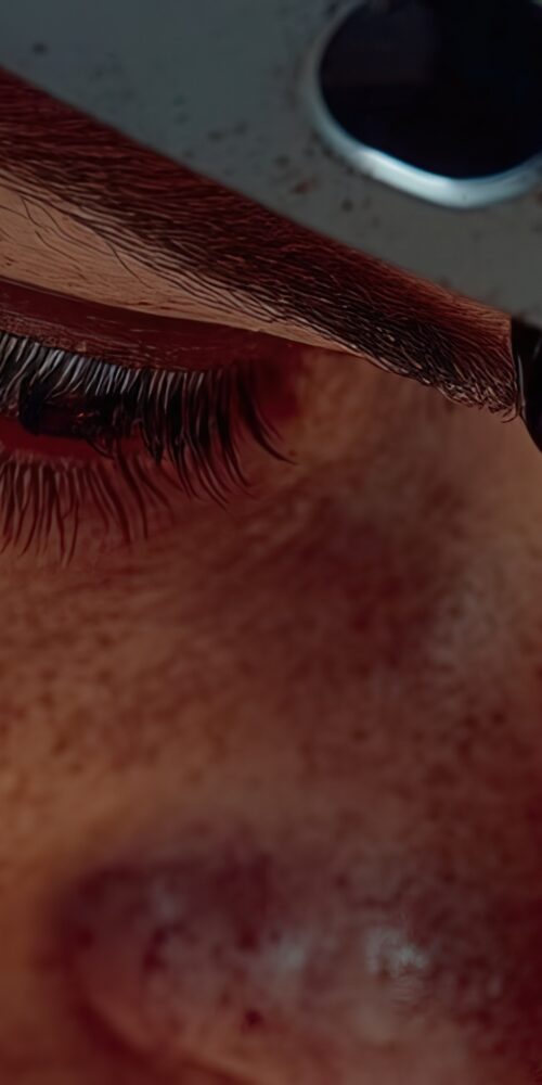 Close-up of an NDT inspection engineer wearing a protective visor with thermal reflections, representing the precision and focus required for advanced composite materials inspection in aerospace and defense manufacturing